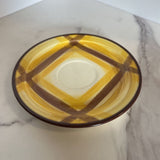 brown and yellow plaid cup and saucer set