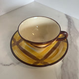 brown and yellow plaid cup and saucer set