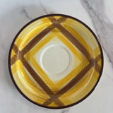 brown and yellow plaid cup and saucer set