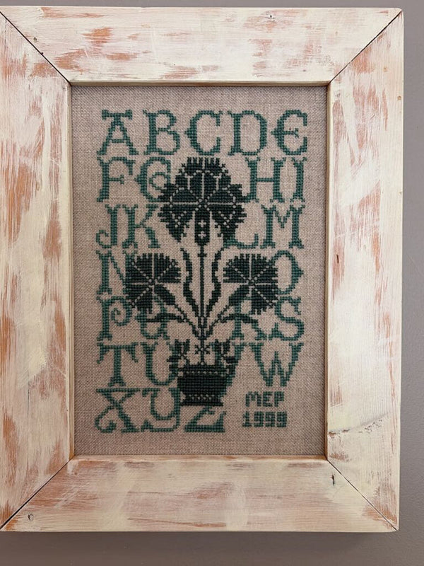 framed green alphabet sampler