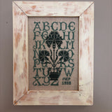 framed green alphabet sampler