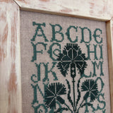 framed green alphabet sampler