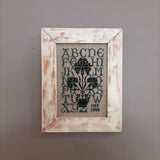 framed green alphabet sampler