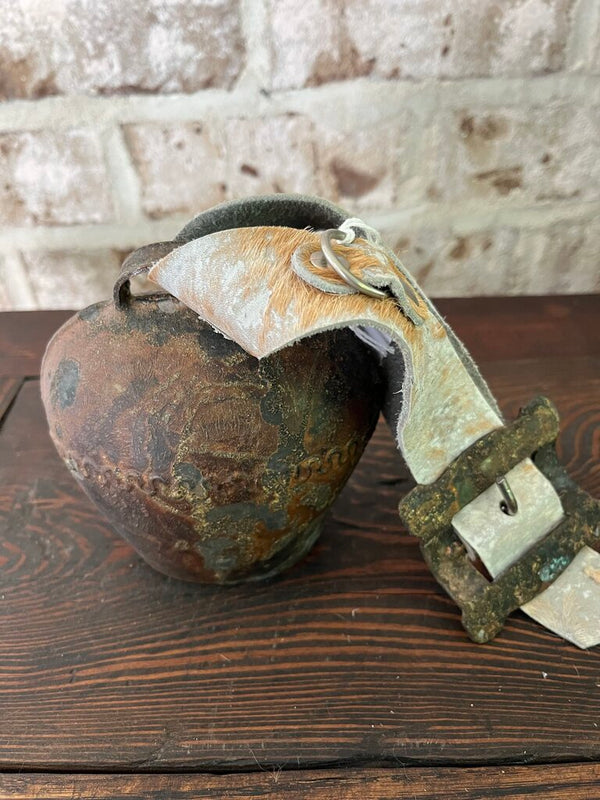 Rusty bell with cowhide strap