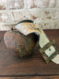 Rusty bell with cowhide strap