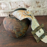 Rusty bell with cowhide strap