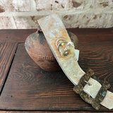 Rusty bell with cowhide strap