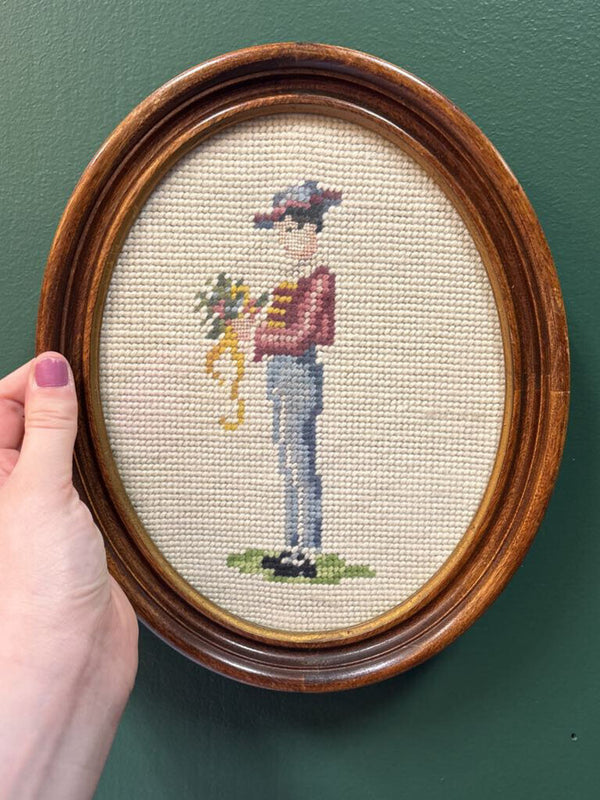Man Holding Flowers Framed Oval Needlepoint