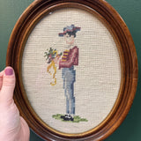 Man Holding Flowers Framed Oval Needlepoint