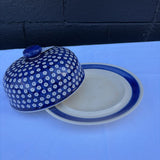 Polish pottery plate with cover in a blue and white pattern
