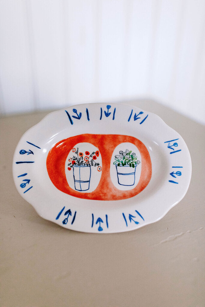 red background floral dish with scalloped edges