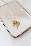bow pendant necklace in gold